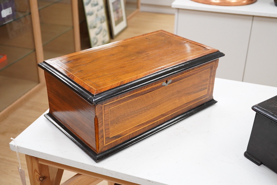 A 19th century Swiss cylinder music box, in a walnut and kingwood cross banded case, with 43 tooth cylinder (missing one tooth), and three bells with butterfly hammers, playing eight airs, cylinder 15.5cm long, case 48cm